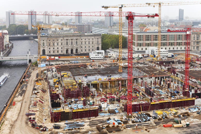a construction site with cranes and buildings