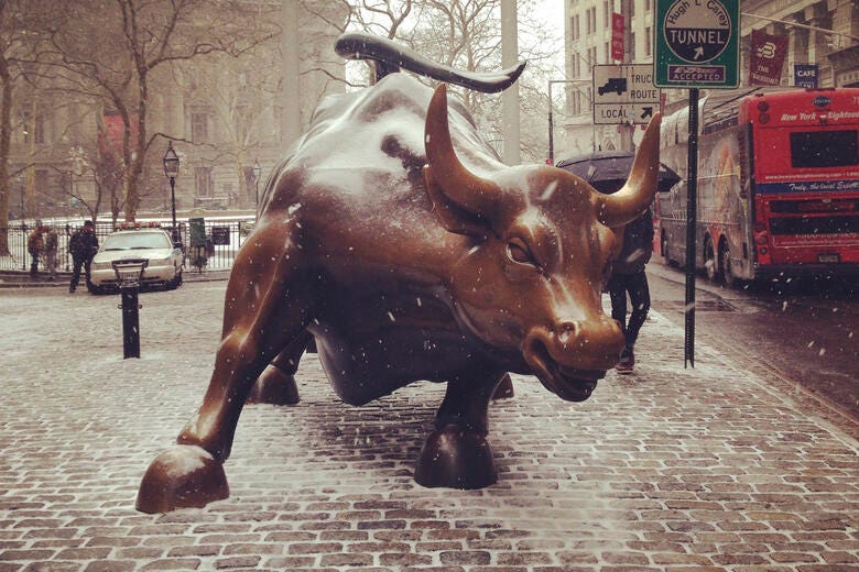 a statue of a bull on a brick road